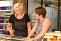 Two female baker, saleswoman in bakery selling fresh bakery products Royalty Free Stock Photo