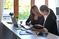 Two female business colleagues having discussion their new project together in office. Royalty Free Stock Photo