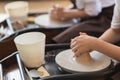 Two female ceramic artists in apron using clay material working in potter studio. Evening freelance distance learning Royalty Free Stock Photo