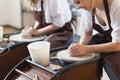 Two female ceramic artists in apron using clay material working in potter studio. Evening freelance distance learning Royalty Free Stock Photo