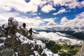 Two female climbers on a snowy and exposed ridge in the Dolomites