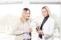 Two female collegues looking at mobile phone Royalty Free Stock Photo