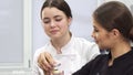 Two female confectioners making macaroons with creamy filling