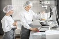 Confectioners working at the bakery manufacturing