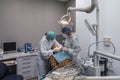 Two female dentists working with their patient`s open mouth. Dentist and nurse is examining teeth of patient. Royalty Free Stock Photo