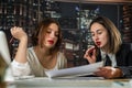 Two female designer work together and discussing about perfect house plan and renovation Royalty Free Stock Photo