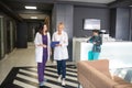 Two female doctors walking in the clinic corridor Royalty Free Stock Photo