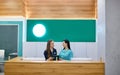 Two female doctors working at reception desk Royalty Free Stock Photo