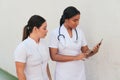 Two female doctors working on a tablet outside the hospital Royalty Free Stock Photo