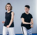 Two female fighter of martial arts practice in gym. Taekwondo coach and student in personal training. Self-defense class for women Royalty Free Stock Photo