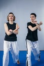 Two female fighter of martial arts practice in gym. Taekwondo coach and student in personal training. Self-defense class for women Royalty Free Stock Photo