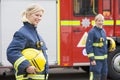 Two female firefighters by a fire engine Royalty Free Stock Photo