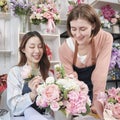 Two female florist entrepreneurs arranged bunch of blossoms in flower .shop Royalty Free Stock Photo