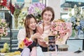 Two female florists demonstrate flower arrangements via online live streaming. Royalty Free Stock Photo