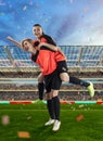 Two female soccer players celebrating victory on soccer filed Royalty Free Stock Photo