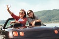 Two female freinds take selfie photo in cabriolet car with beaut Royalty Free Stock Photo