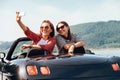 Two female freinds take a selfie photo in cabriolrt car during t Royalty Free Stock Photo