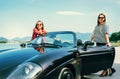 Two female freinds traveling by cabriolet Royalty Free Stock Photo