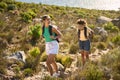 Two Female Friends With Backpacks On Vacation On Hike Through Countryside Next To Sea Royalty Free Stock Photo