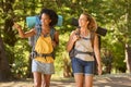 Two Female Friends With Backpacks On Vacation Hiking Through Countryside Together Royalty Free Stock Photo