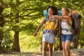 Two Female Friends With Backpacks On Vacation Hiking Through Countryside Together Royalty Free Stock Photo