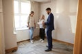 Two Female Friends Buying House For First Time Looking At House Survey With Realtor Royalty Free Stock Photo