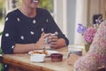 Two Female Friends In Coffee Shop Meeting Up In Socially Distanced Way Viewed Through Window Royalty Free Stock Photo