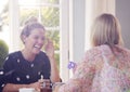 Two Female Friends In Coffee Shop Meeting Up In Socially Distanced Way Viewed Through Window Royalty Free Stock Photo