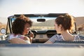 Two Female Friends Enjoying Road Trip In Open Top Classic Car Royalty Free Stock Photo