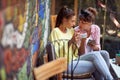 Two female friends gossip while sitting in the bar. Leisure, bar, friendship, outdoor Royalty Free Stock Photo