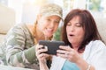 Two Female Friends Laugh While Using A Smart Phone Royalty Free Stock Photo