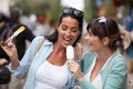 two female friends licking ice cream