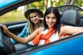 Two friends women on road Trip Driving In Convertible Car Royalty Free Stock Photo