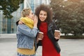 Two female friends sharing secrets outdoors Royalty Free Stock Photo