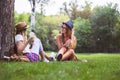 Two female friends sitting on the grass, talking Royalty Free Stock Photo