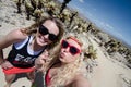 Two female friends take a selfie at the Cholla Cactus Garden in Joshua Tree National Park