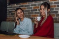 Two female friends talking and drinking coffee in cafe Royalty Free Stock Photo