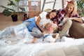 Two female friends talking and smiling to a cute little girl, preparing for renovation apartment. renovation, apartment, moving