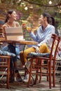 Two female friends toasting while having a drink at the bar. Leisure, bar, friendship, outdoor Royalty Free Stock Photo