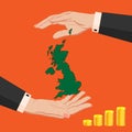 Two female hands around the map of Great Britain with a stack of pound sterling coins Royalty Free Stock Photo