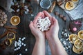 Two female hands holding a bunch of white marshmallow on the tab Royalty Free Stock Photo