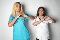 two female medical workers making the heart shape with their hands Royalty Free Stock Photo