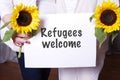 Two female helpers welcome refugees