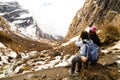 Two female hikers resting while enjoying the serene view of the snowy trek