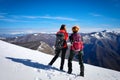 Women hikers explore the snow-capped mountain peaks