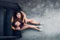 Two female lesbian lgbt couple sitting at black rooftop stair h