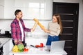 Two female and male competitors struggle for winning culinary contest, target at each other have irritated and furious expressions