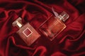 Two female perfumes on red silk Royalty Free Stock Photo