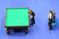 Two female players compete in pool