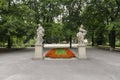 Two female rococo sculptures with a red flowers into saxon gardens